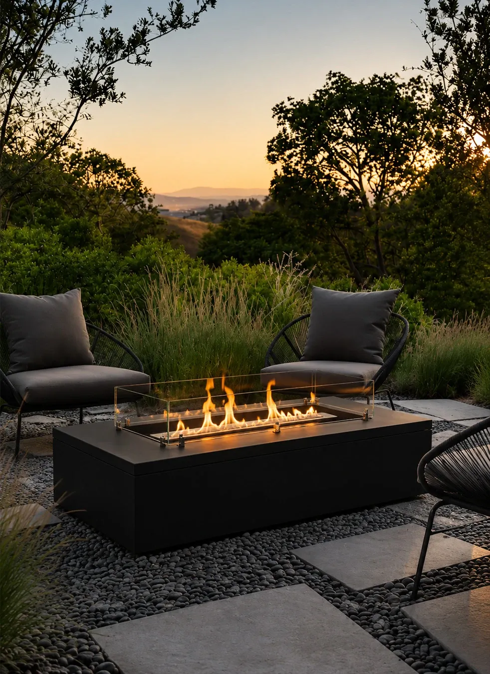 Black bioethanol fire table on a garden terrace at sunset